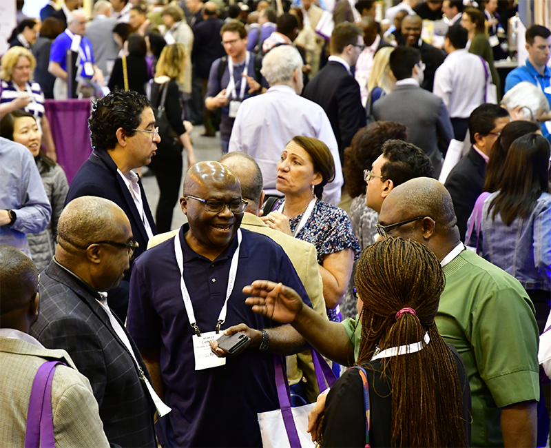 Attendees interacting with exhibitors