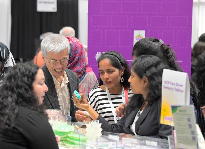 Attendees interacting with exhibitors